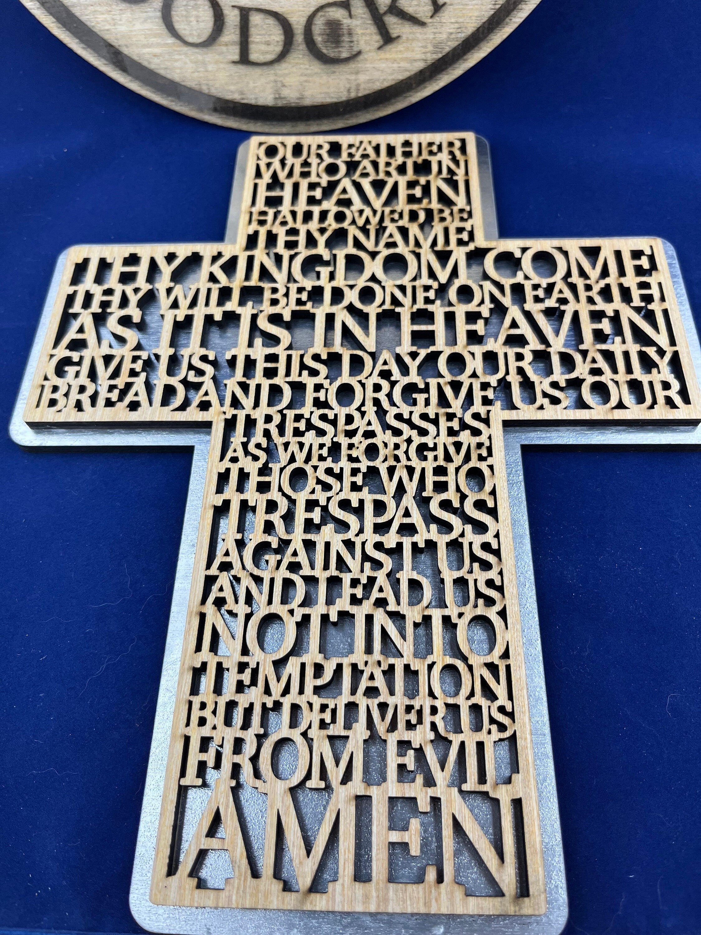Lord prayer laser cut into the sign of cross